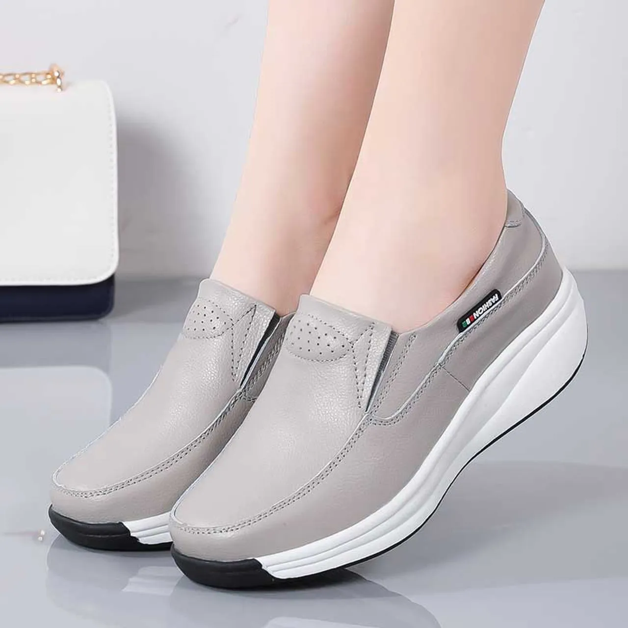 Grey thread accents slip on rocker bottom sneaker