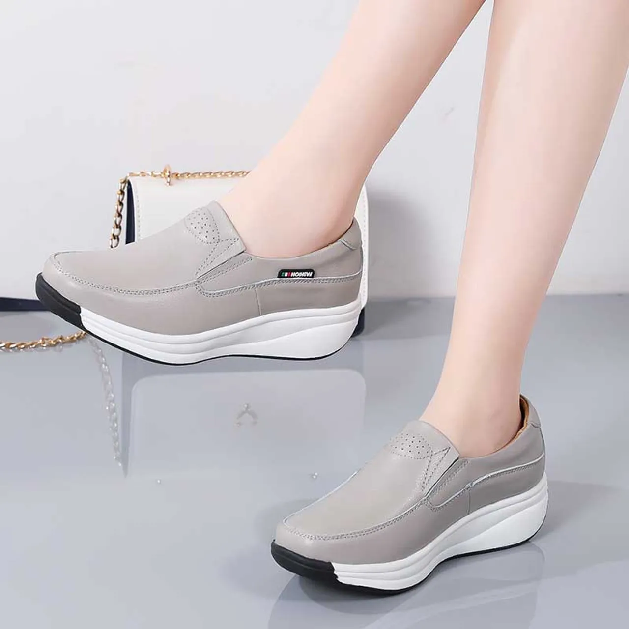 Grey thread accents slip on rocker bottom sneaker