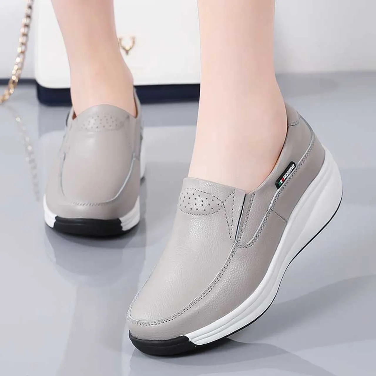 Grey thread accents slip on rocker bottom sneaker