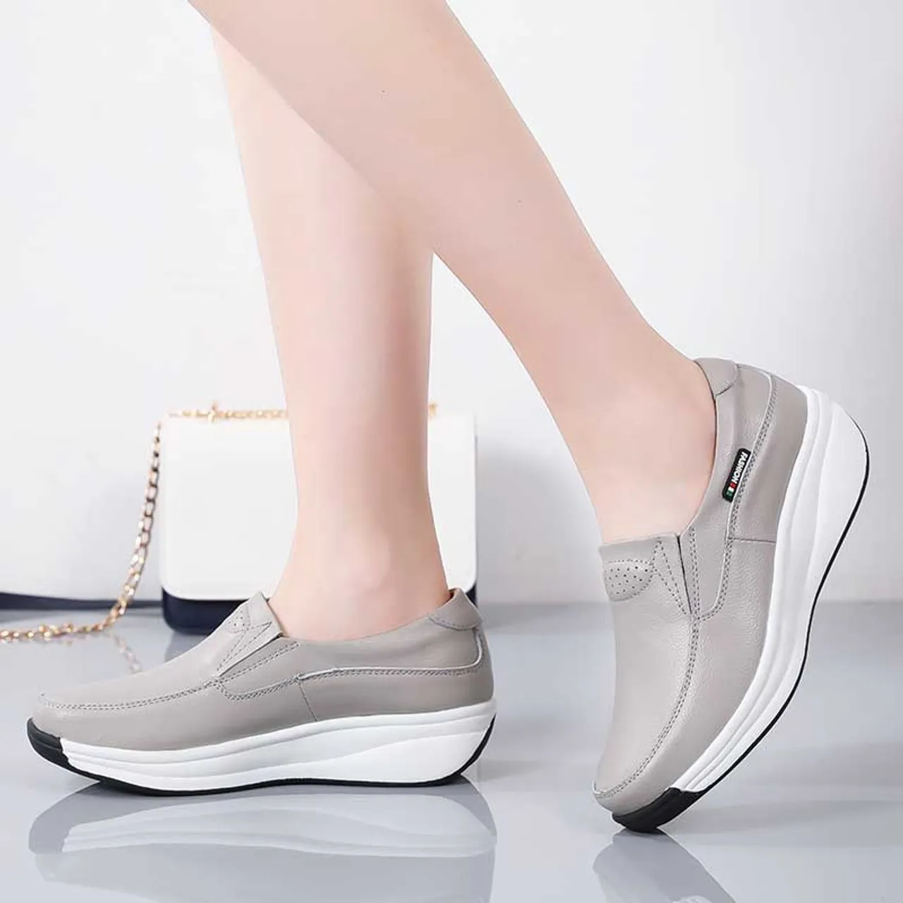 Grey thread accents slip on rocker bottom sneaker