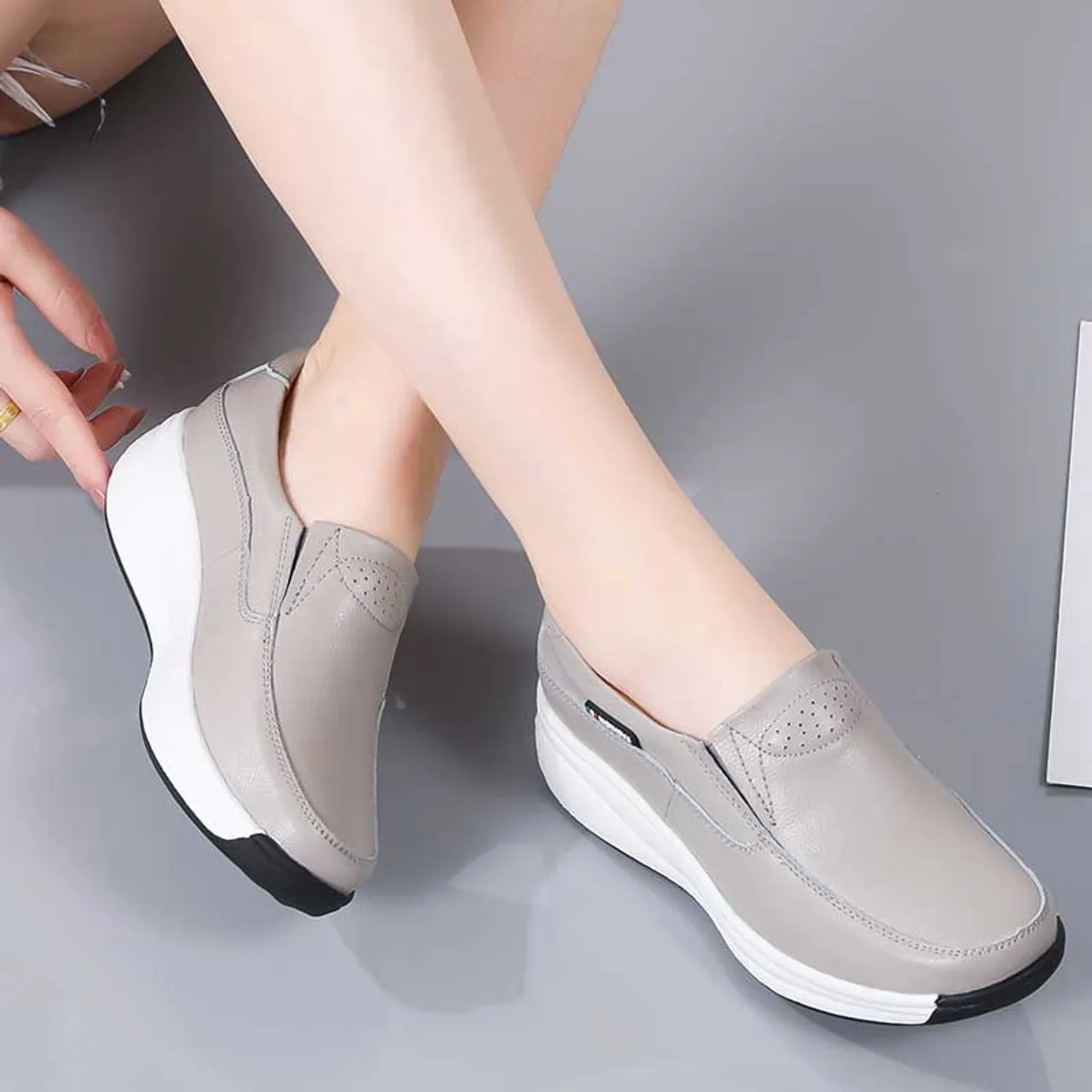 Grey thread accents slip on rocker bottom sneaker